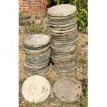 Reconstituted stone circular garden stepping stones decorated with fanciful dragon head and oriental