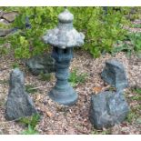 A reconstituted stone Japanese ornamental birdhouse and decorative stones. 74cm high. This lot