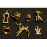 A 9ct gold Poodle charm, marked 375; other 9ct gold charms, fawn, keyhole set with black onyx,