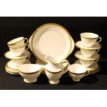 A Royal Doulton Royal Gold part tea service comprising cake plate, dessert plates, side plates,