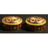 A pair of Royal Crown Derby Imari palette 1128 pattern oval trinket pots and covers, solid gold