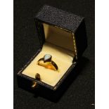 A 9ct gold ring set with a single tear drop shaped polished opal cabochon, 4.4g, boxed