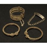 A silver identity bracelet, hallmarked; a white metal filigree bangle; two bracelets (4)