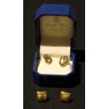 A pair of 18ct yellow and white gold inter-looped earrings, marked 750, 18ct gold backs, 1.43g,