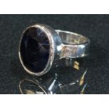A 925 sterling silver ring, set with a faceted dark blue stone
