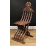 A late 19th/early 20th century Syrian Arabesque folding chair, shaped cresting rail carved with