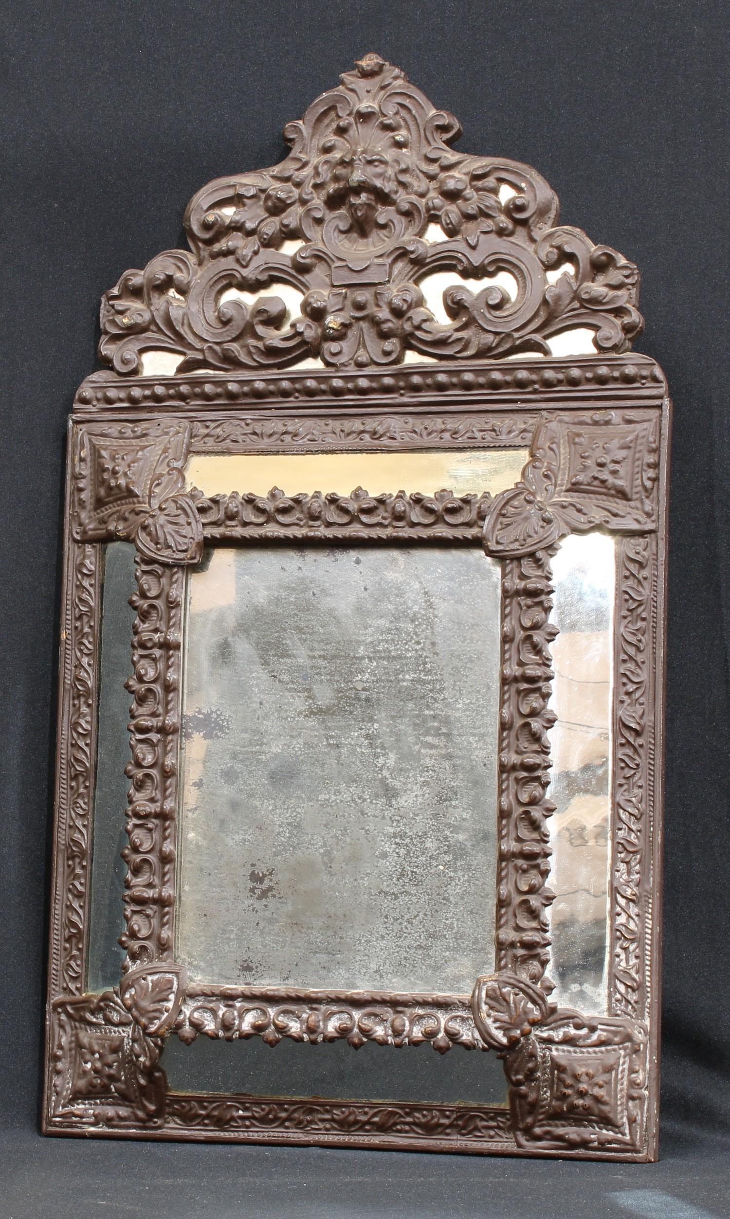 A 19th century French repousse cushion mirror, 59cm high