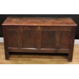 An 18th century oak blanket chest, hinged top above a four panel front, 69cm high, 126cm wide, 51.