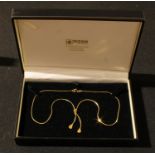 An 18ct gold droplet necklace, marked 750, 5.16g, boxed