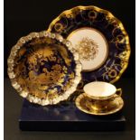 A Royal Crown Derby Gold Aves tea cup, saucer and dessert plate, cobalt blue ground, heraldic