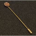 A 9ct gold stock pin, set with a single faceted ruby stone, all marked 9ct, 1.7g