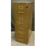 A Vintage green painted metal four drawer filing cabinet, 132cm high, 45cm wide, 61.56cm deep