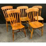 A near set of four beech and elm kitchen chairs, lath backs, saddle seat, H-stretchers, turned legs