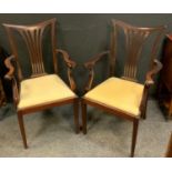 A pair of early 20th century mahogany carvers, outswept arms, drop-in seats, tapered square legs,