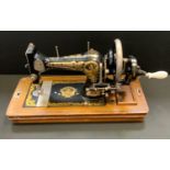 A Frister & Rossmann hand operated sewing machine, no 3241831, mahogany case.