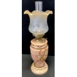 A late 19th/early 20th century oil lamp, etched glass shade, vasular body decorated with