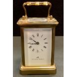 A carriage clock by Matthew Norman, with white enamel dial with Roman numerals and makers name,