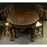 A late Victorian mahogany extending dining table, oval top, one additional leaf, carved legs, ball