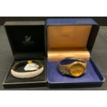 A Swarovski crystal hinge bangle, cased; a Seiko day date quartz bracelet wristwatch, ref 7N43-9011,