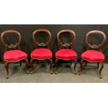 A set of four Victorian mahogany balloon back dining chairs, carved horizontal splat, stuffed over