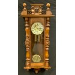 A 19th century mahogany Vienna wall clock, 20.5cm circular dial with Roman numerals, 117cm overall