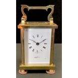 A brass carriage clock by H.L.Brown, Swiss movement, Roman numerals. 15cm high.