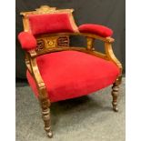 A Victorian rosewood tub chair, inlaid cresting rail, padded arms and seat, turned legs, casters,