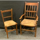 A 19th century oak elbow chair, rush seat; another oak side chair, rush seat,(2)