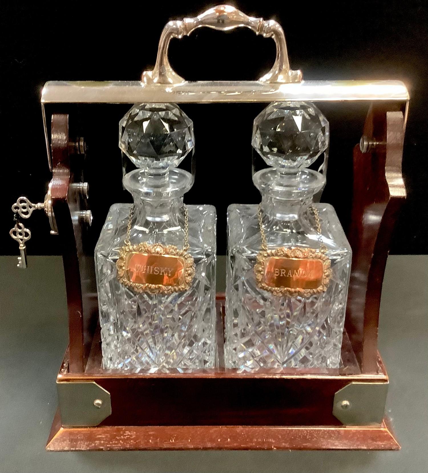 A silver plated two bottle tantalus by Viners, Sheffield, plated whisky and brandy labels.