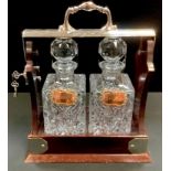 A silver plated two bottle tantalus by Viners, Sheffield, plated whisky and brandy labels.