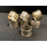 Three Edwardian silver napkin rings, engraved and chased, Chester 1908; others (7)