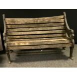 A cast iron wooden slatted garden bench.