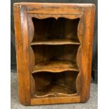 A George III oak open fronted wall hanging corner cabinet, shaped triple shelf aperture, canted