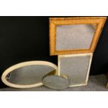 A modern wall hanging looking glass, bevelled oval mirror, 67cm wide; other various mirrors.(4)