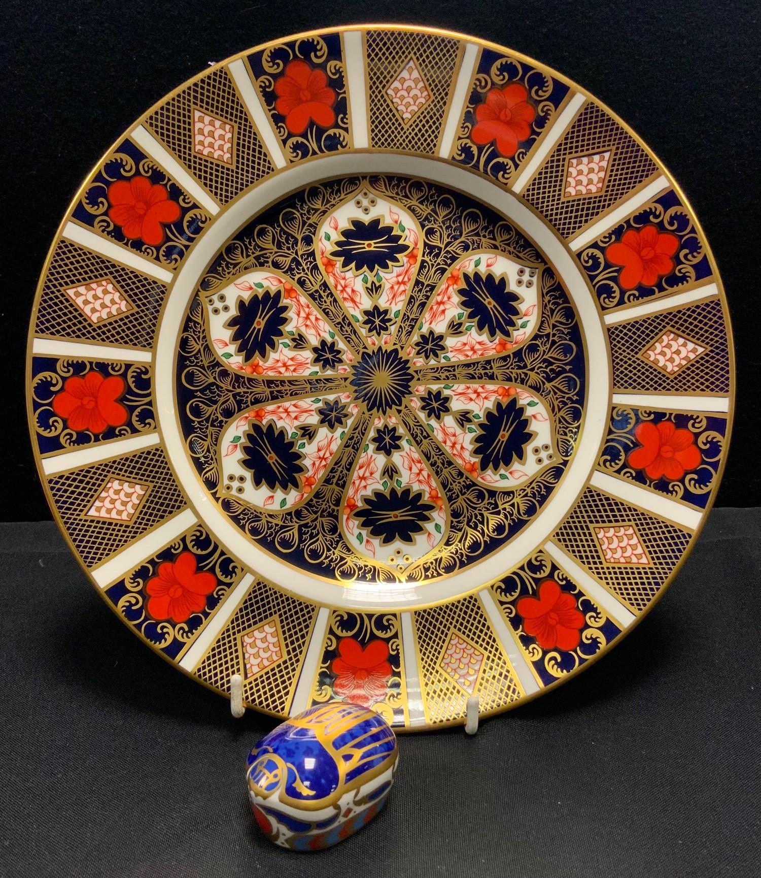 A Royal Crown Derby 1128 imari dinner plate, 26.5cm diameter, 1st; a Millennium Bug paperweight,