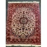 A Middle Eastern handwoven rug decorated with floral patterns in tones of steel blue, indigo and