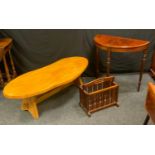 A late 20th century light oak coffee table, shaped top, 42cm high, 132cm wide, a reproduction demi-