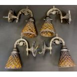 Four reproduction metal wall sconces, conical glass shades.