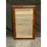 A Victorian walnut wall hanging looking glass, rectangular bevelled mirror, 46cm high 29cm wide.