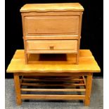 A light oak coffee table with pegged joints, slatted under tier, maker?s mark AL 1980 carved to