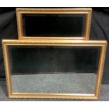 A pair of gilt wood framed rectangular wall mirrors. 58.5cm x 83.5cm overall.