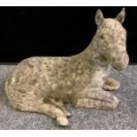 A reconstituted stone recumbent horse. 34cm high x 45cm long.