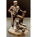 A bronzed spelter figure group, huntsman and his gun dog.