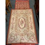 An aubusson needlework rug, rose on a cream ground, 180cm x 118cm; a Tunisian hand knotted runner,