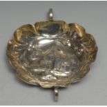 A 17th/18th century German silver shaped oval wine taster, chased with buildings within a band of
