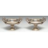 A pair of Grand Tour design electroplated half-fluted saucer shaped mantel urns, divided acanthus