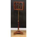 A Regency parcel-gilt rosewood and walnut duet music stand, each adjustable plateau centred by a