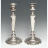 A pair of large George III Old Sheffield plate table candlesticks, campana sconces, tapered pillars,