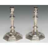 A pair of 18th century French silver octagonal table candlesticks, knopped pillars, dished stepped