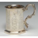 A Victorian Gothic Revival silver octagonal mug, engraved with leafy C-scrolls and cartouches,